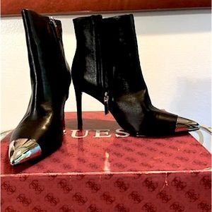 Calvin Klein black ankle bootie, with silver tip.